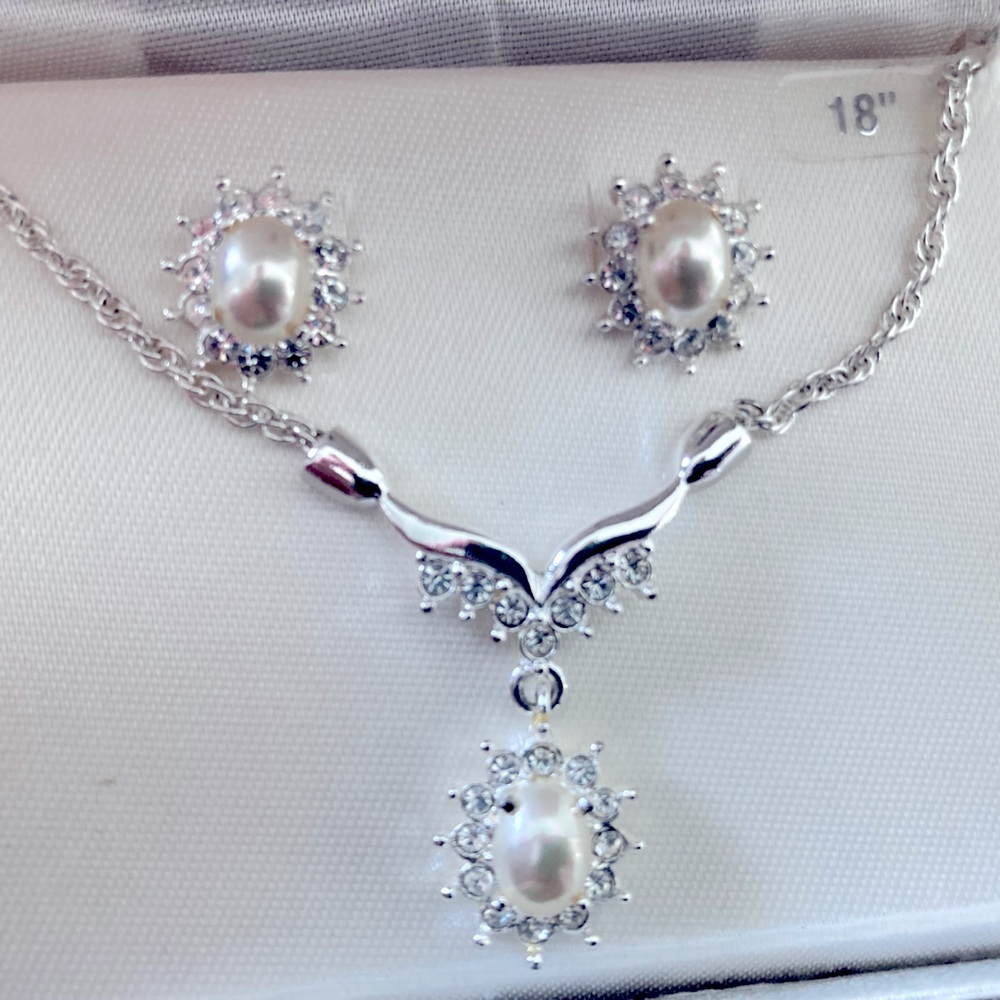 Roman pearl with clear stones surrounding necklace and earrings. Silver necklace